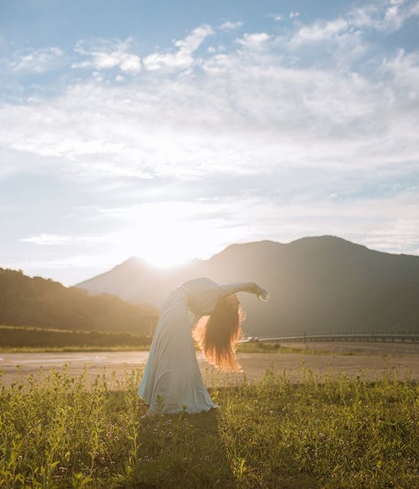 Silhouette of a person in a gentle, flowing yoga pose.